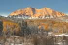 USA, Colorado, Gunnison National Forest. Snow on East Beckwith Mountain and forest in autumn. Art Print